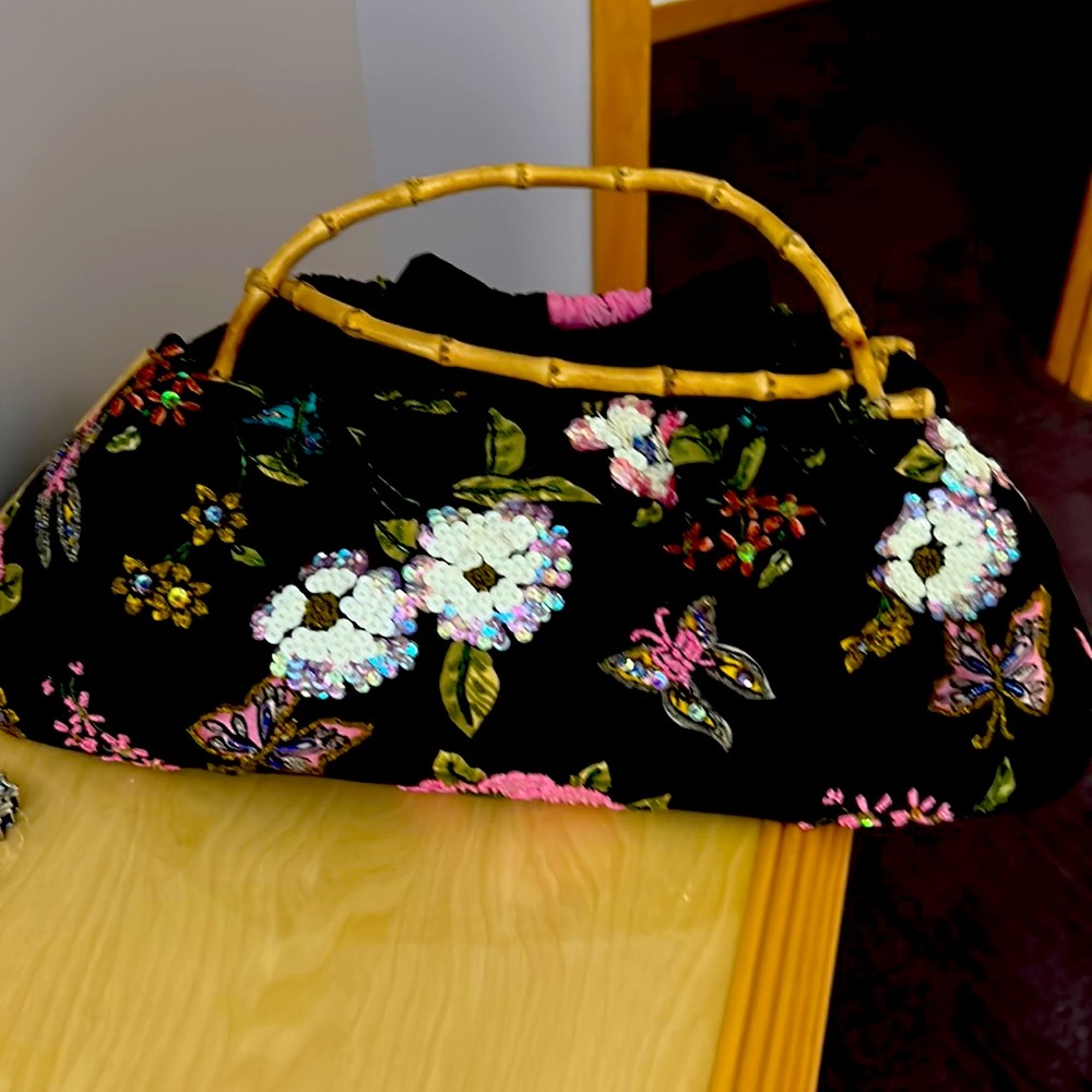 Gorgeous woman bag with bamboo handles black color with sparkling flowers.New